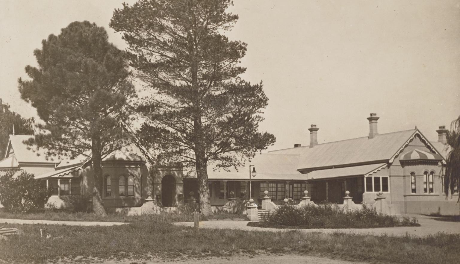 Sepia-toned photograph of a large house