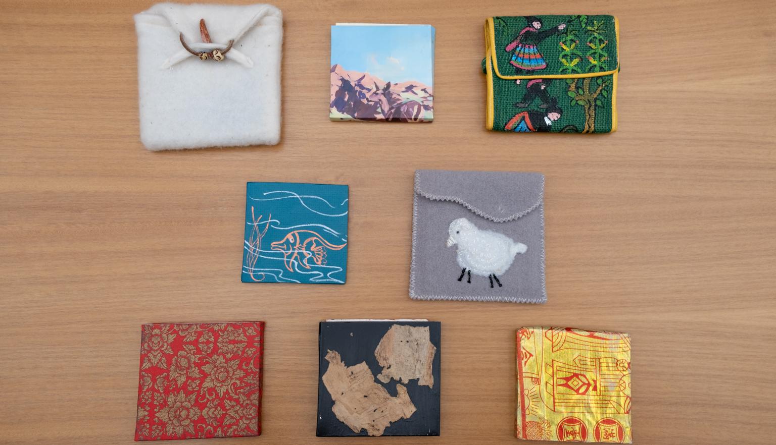 Small handmade fabric bags and slipcases of various colours, designs and materials