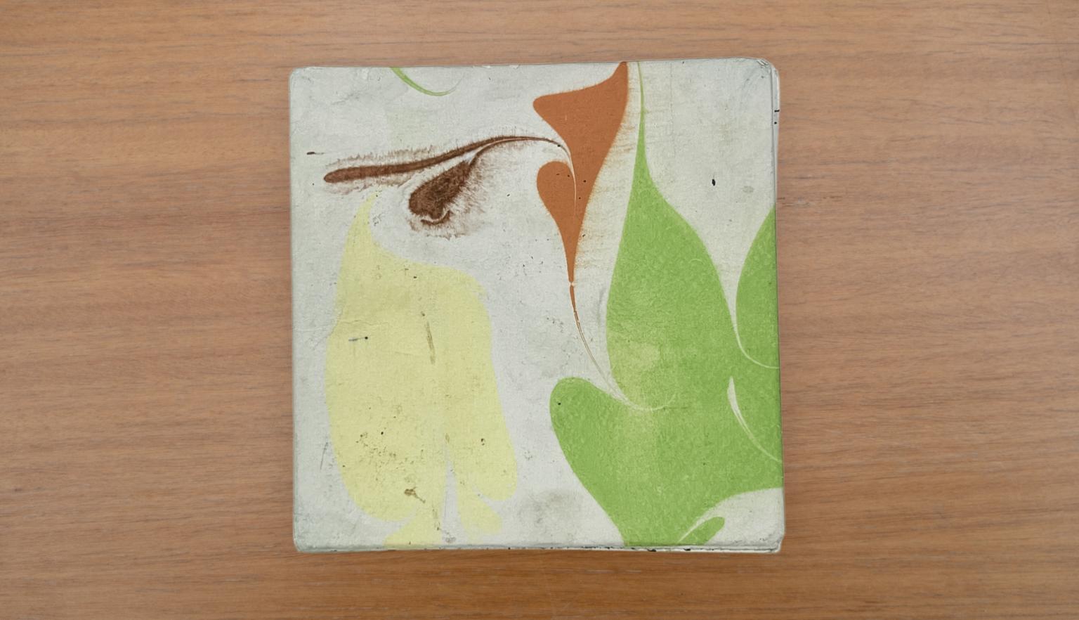 Travel diary back cover with an abstract green, yellow, orange and white design