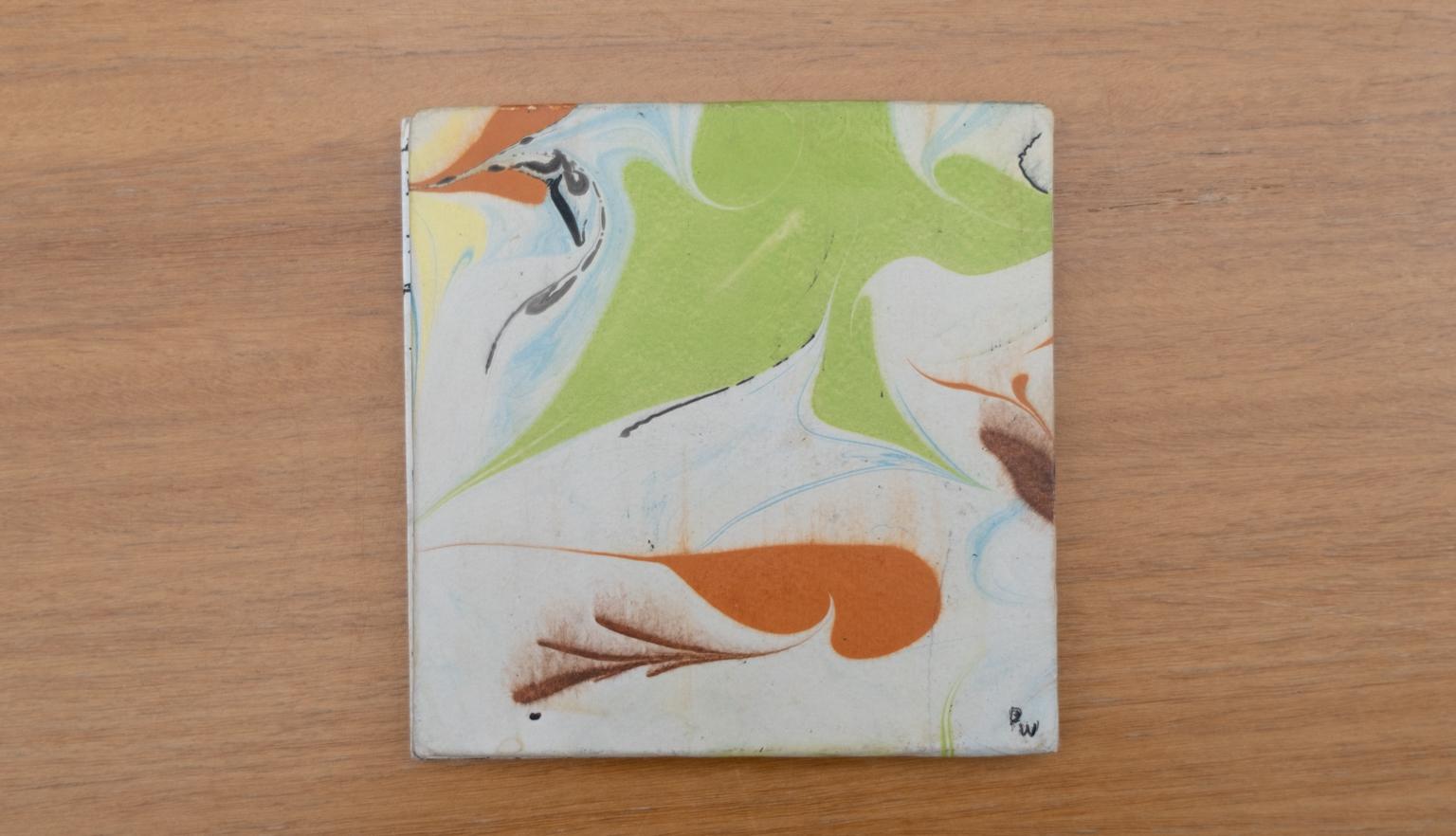 Travel diary cover with an abstract green, yellow, orange and white design