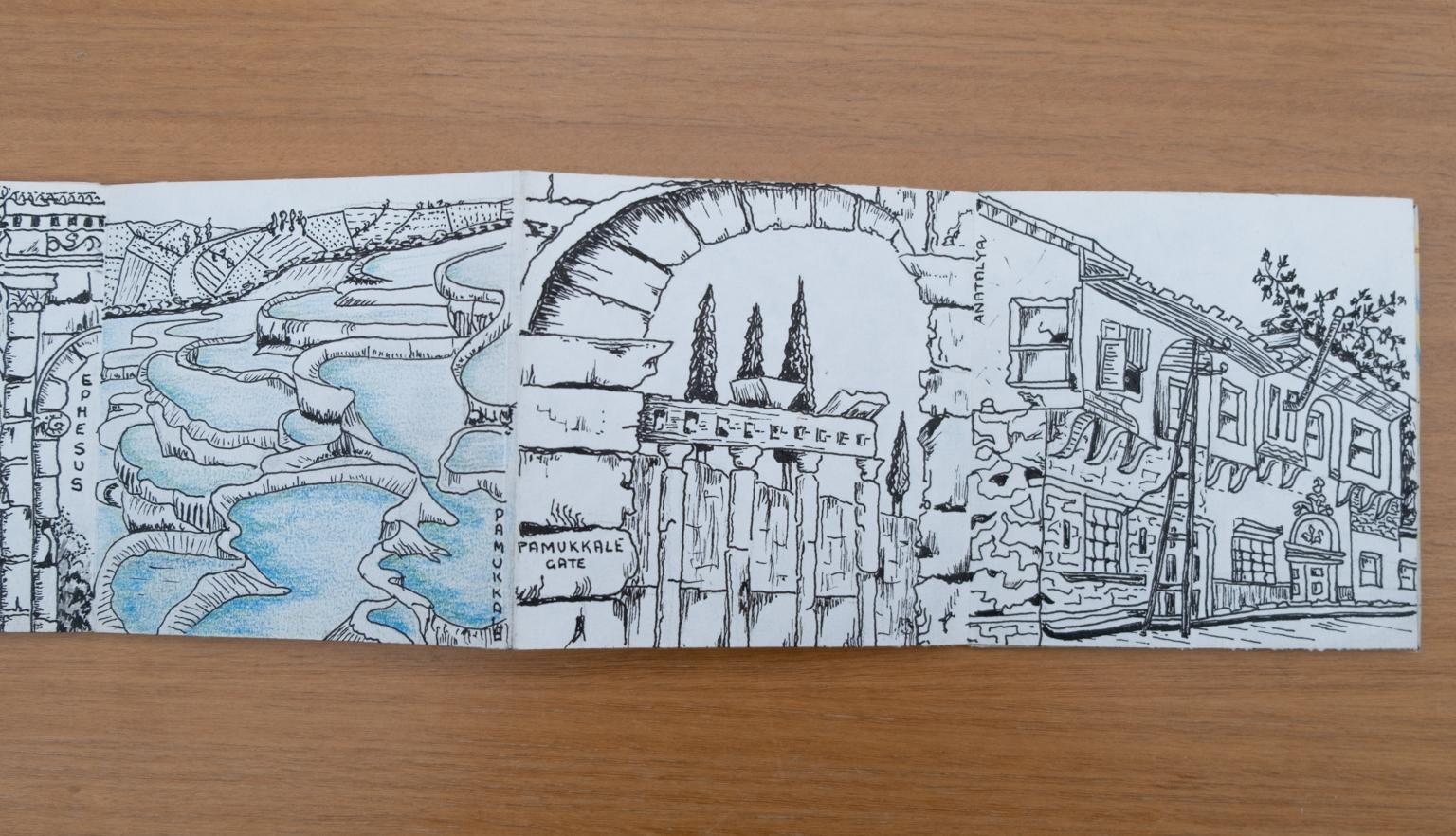 Fold-out travel diary open to three pages with black and white illustrations of rock pools and architecture in Turkey
