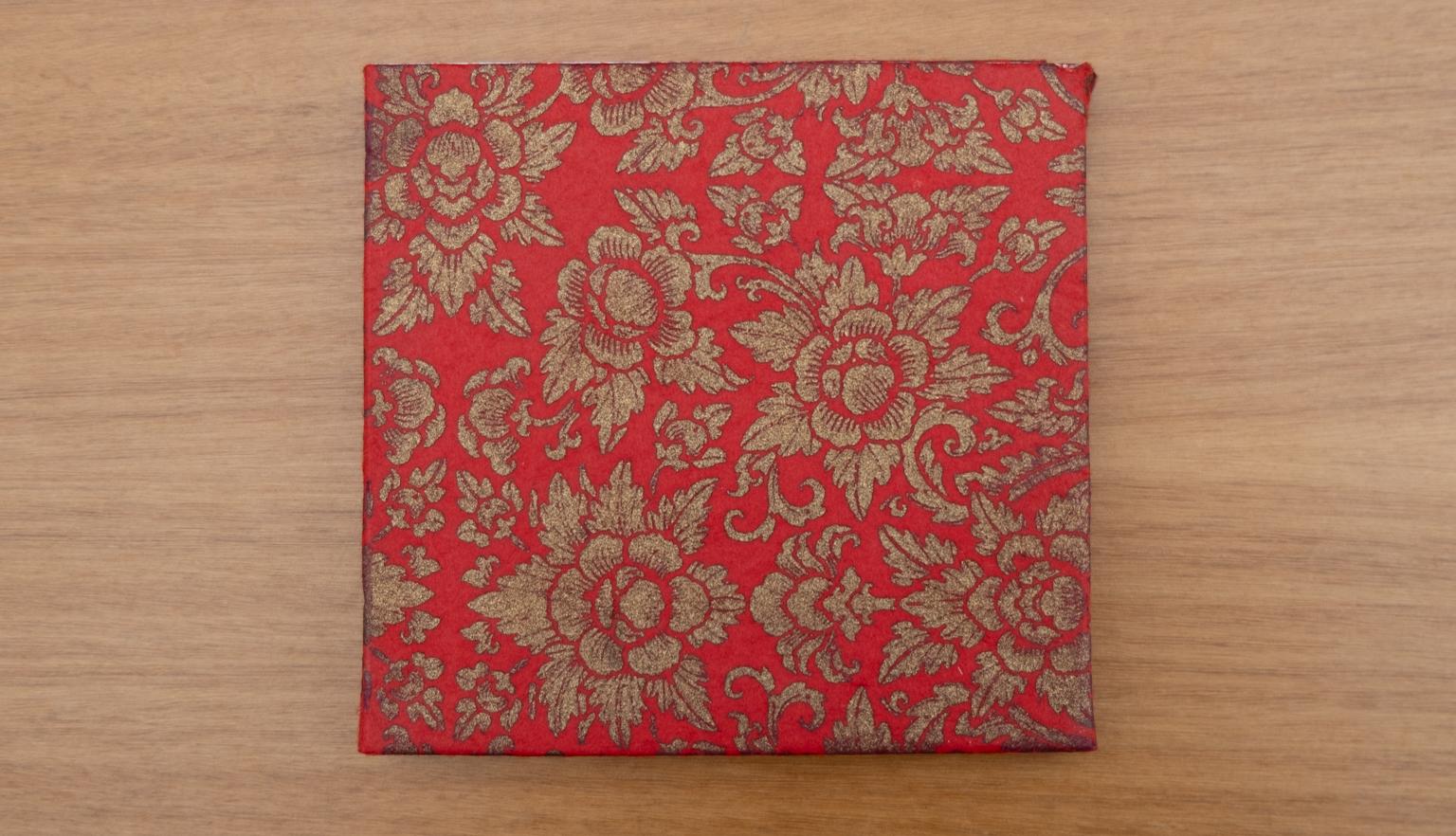 Red and brown fabric slipcase with floral pattern