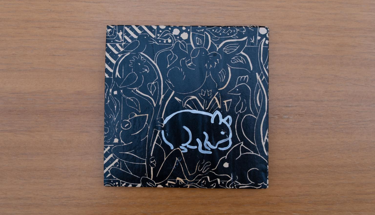 Travel diary cover with a black background and brown and white illustrations of Australian plants and animal, including a wombat and a koala