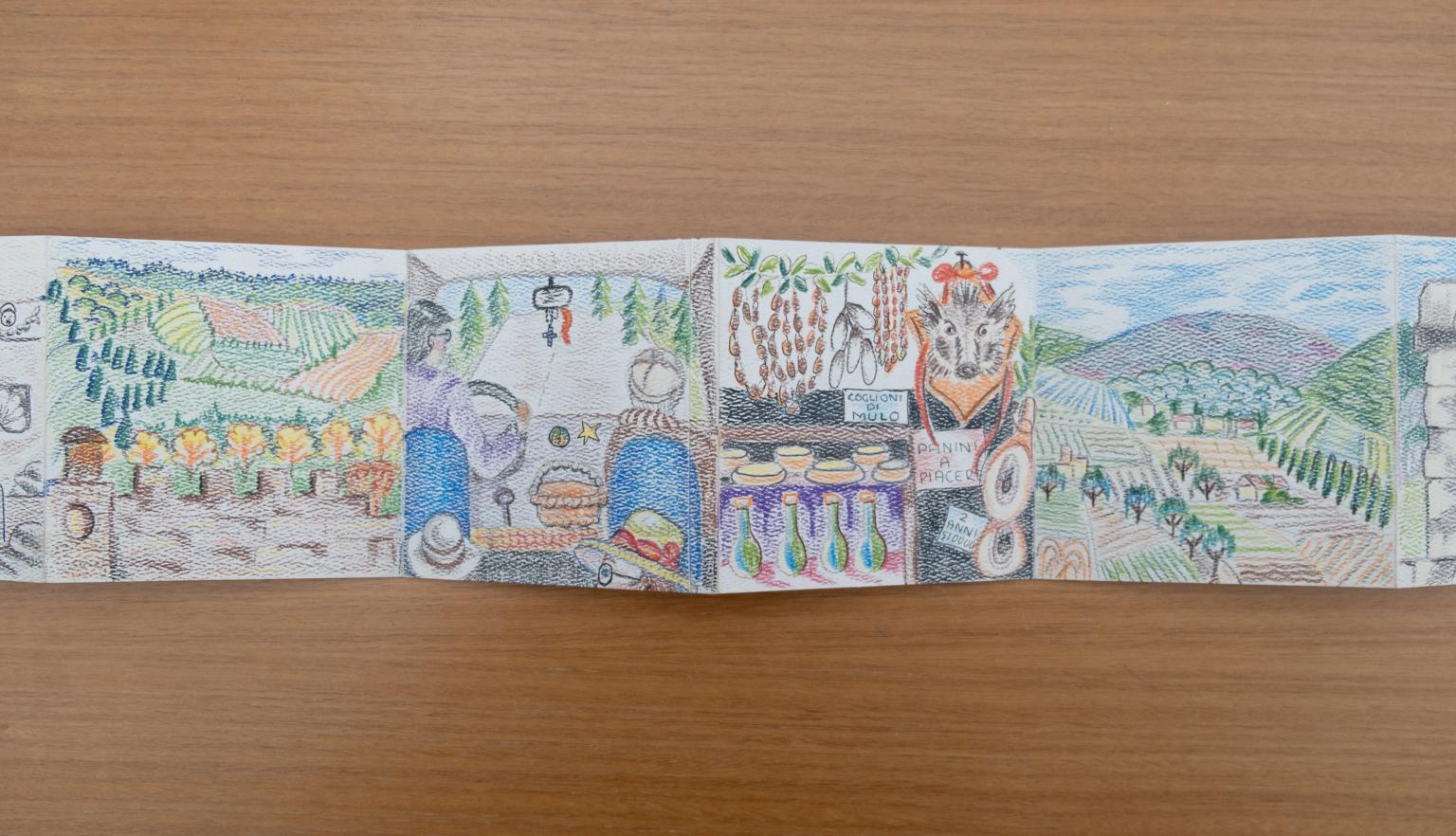 Fold-out travel diary open to four pages with colourful illustrations of orchards, people in a car and a market stall