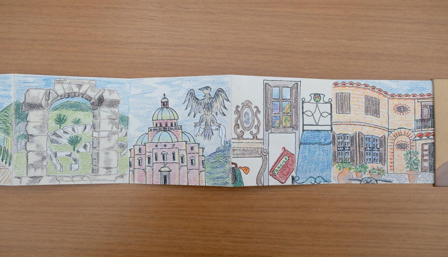 Fold-out travel diary open to four pages with colourful illustrations of a stone archway in a ruin, a large ornate building, a bedroom and a brick building