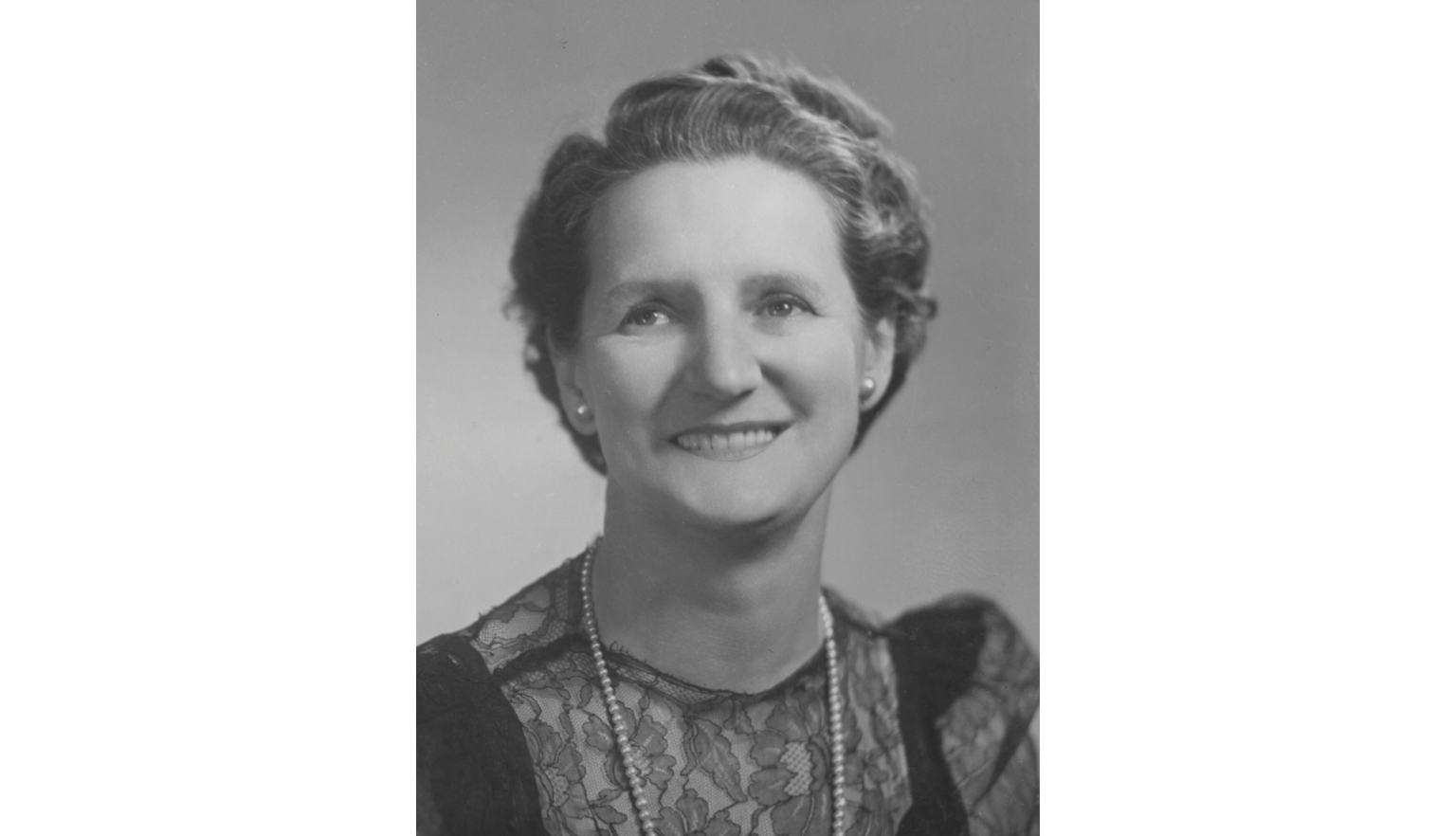 Black and white photographic portrait of Ivy Wedgwood smiling