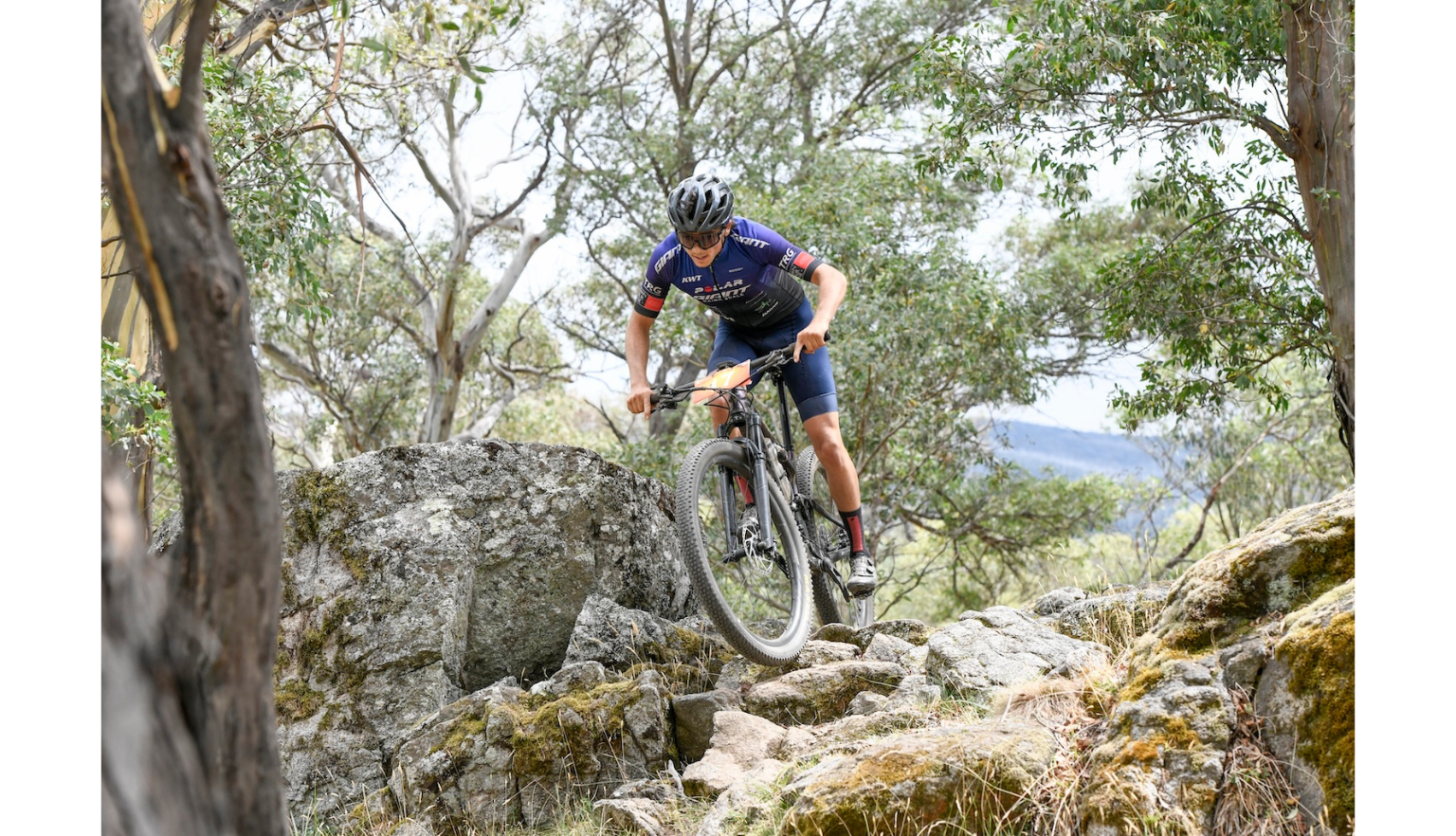 Mountain biker riding along rocks in a race