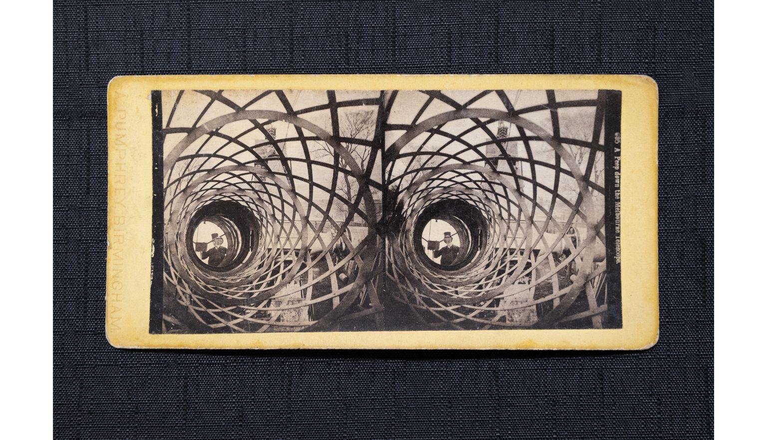 The interior of a telescope with a man visible at the exit.