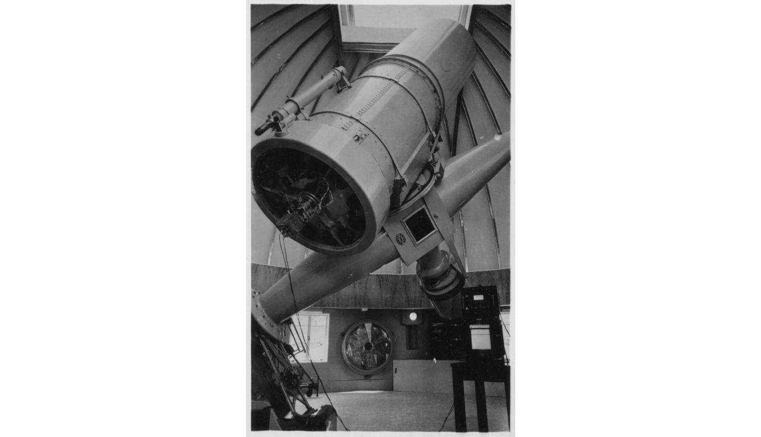 A photograph of an optical telescope within a dome structure. 