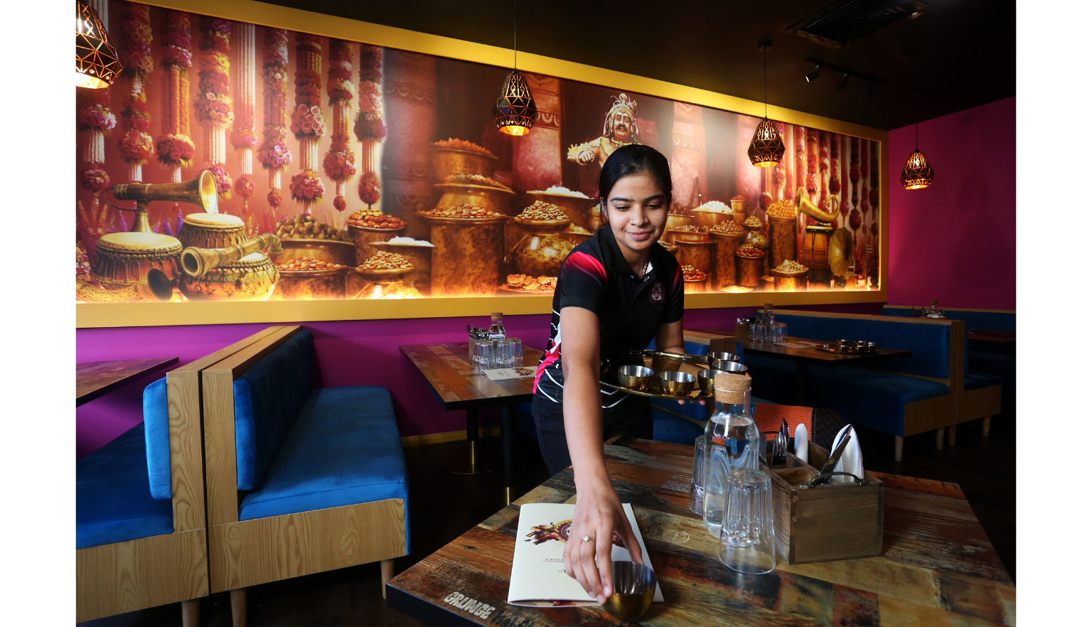 Young woman preparing a table in a restaurant