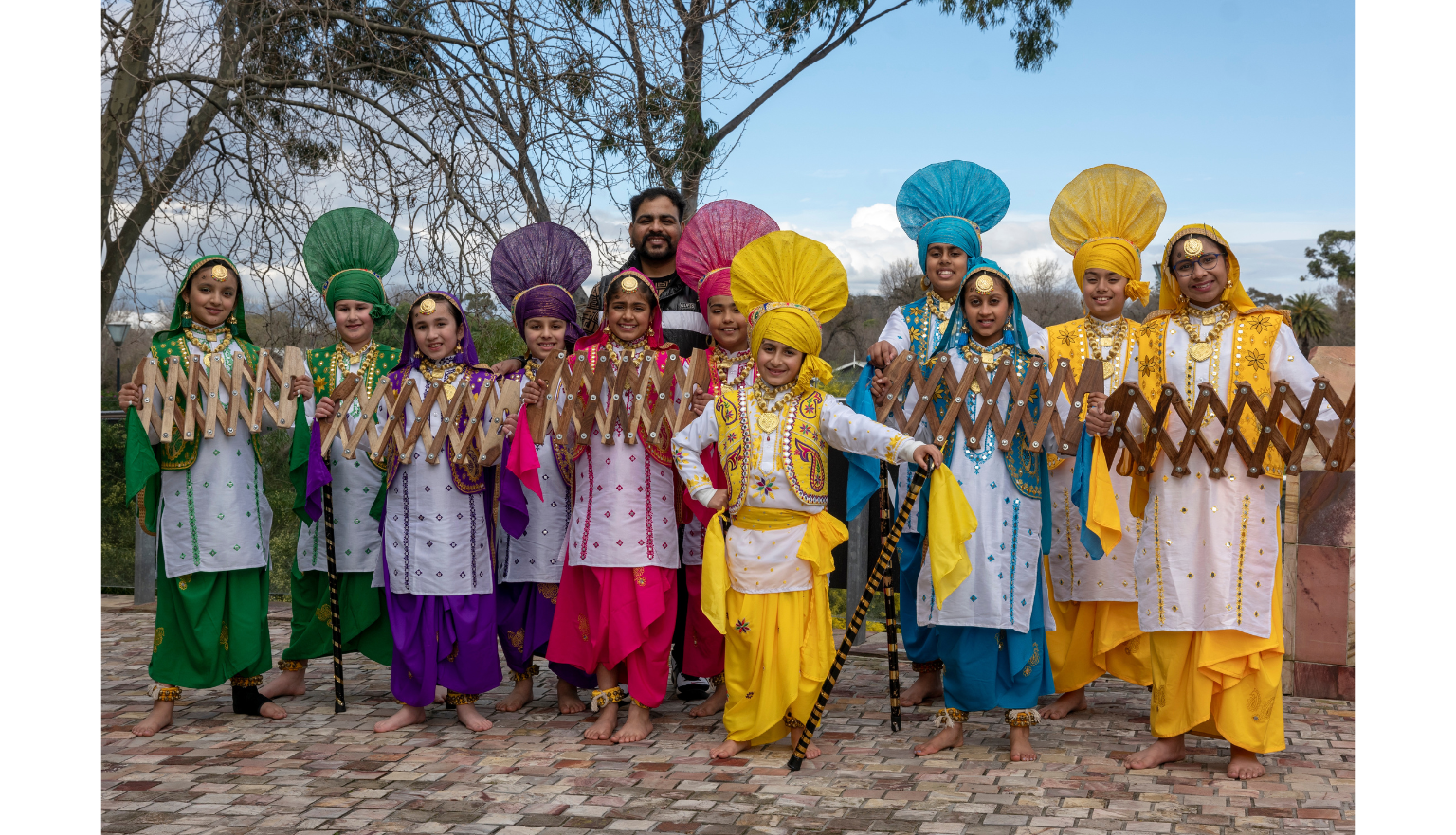 Children in differently coloured, traditional outfits with large headpieces, 