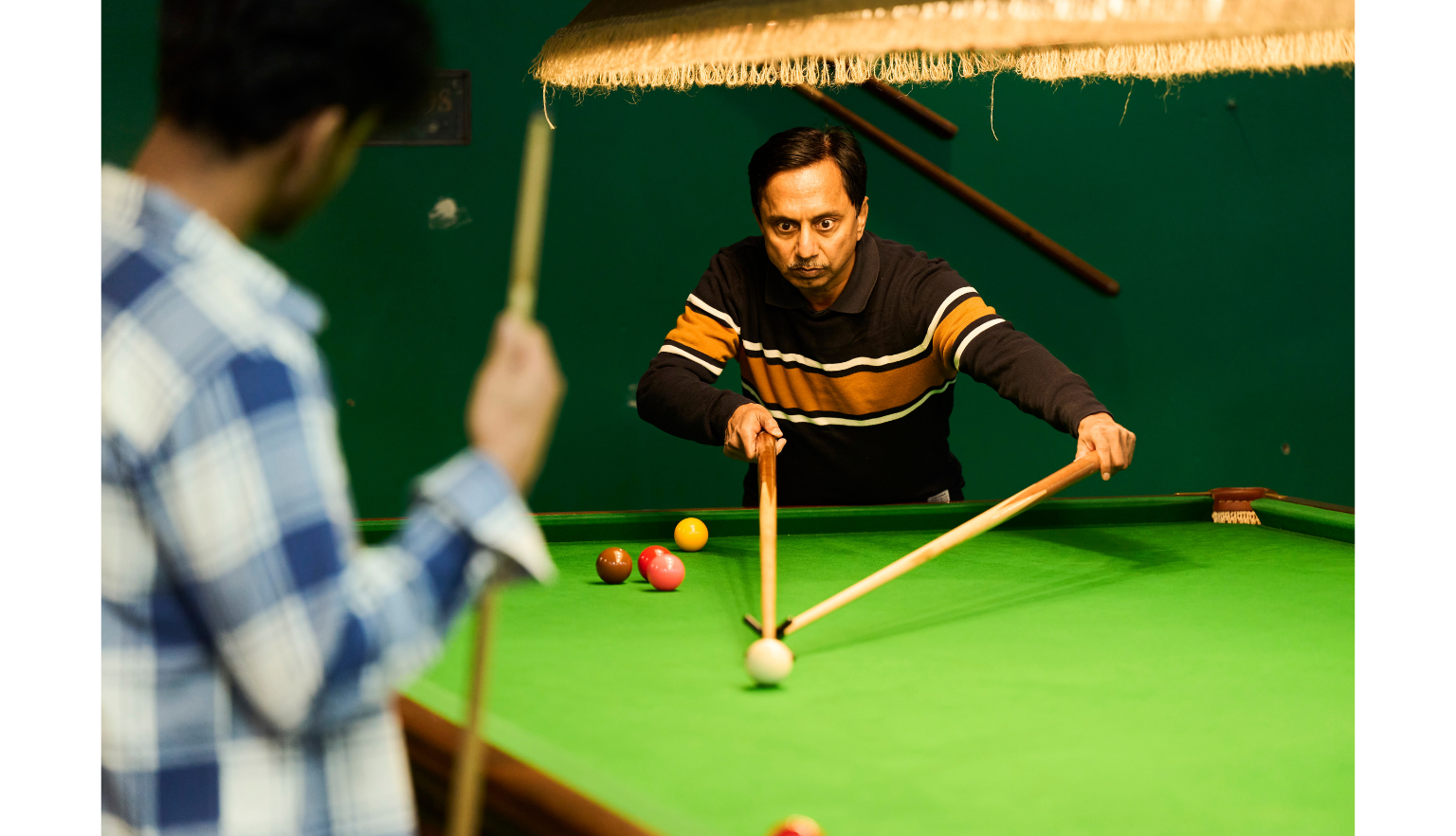 Man making a move in a game of snooker