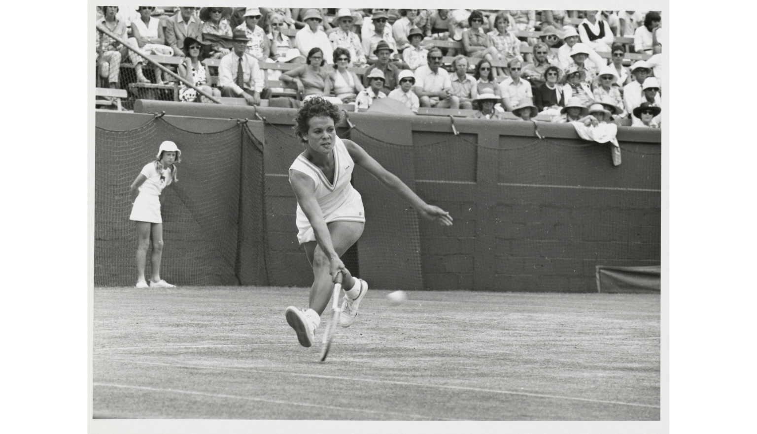 A black and white photograph with Evonne Goolagong playing a tennis shot