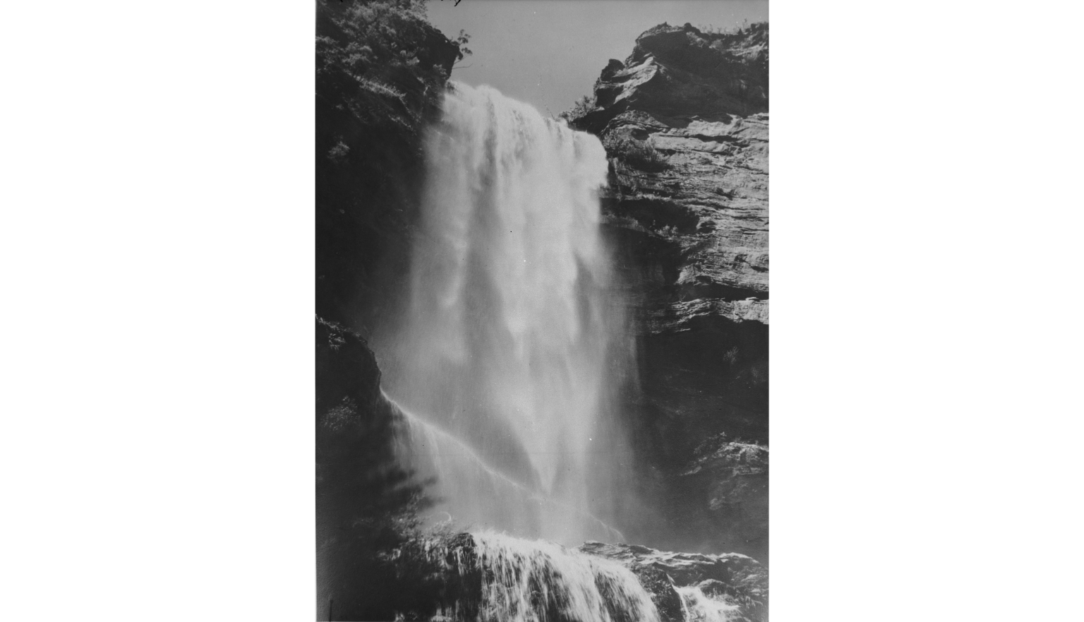 Black and white photo of a large waterfall