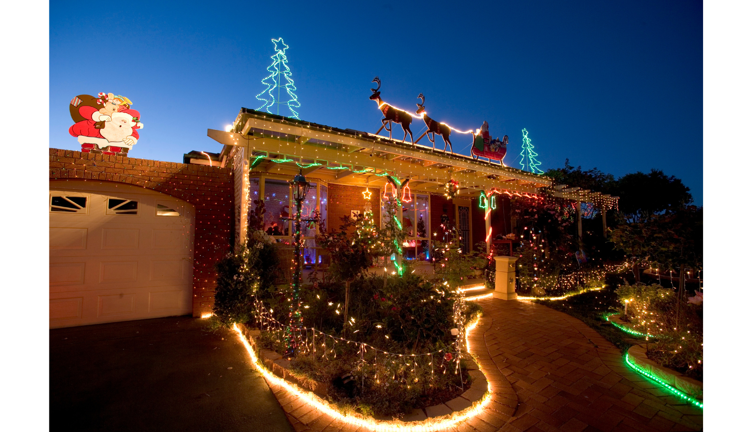 A one-story house decorated with Christmas lights