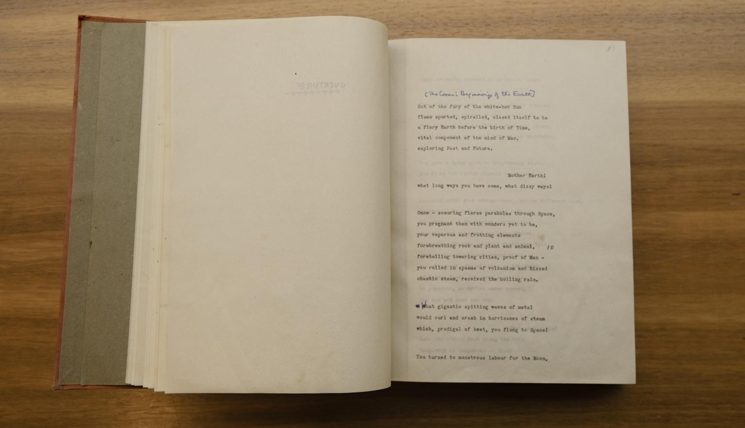 Book open to a make with type-written words of a poem with handwritten annotations and minor edits