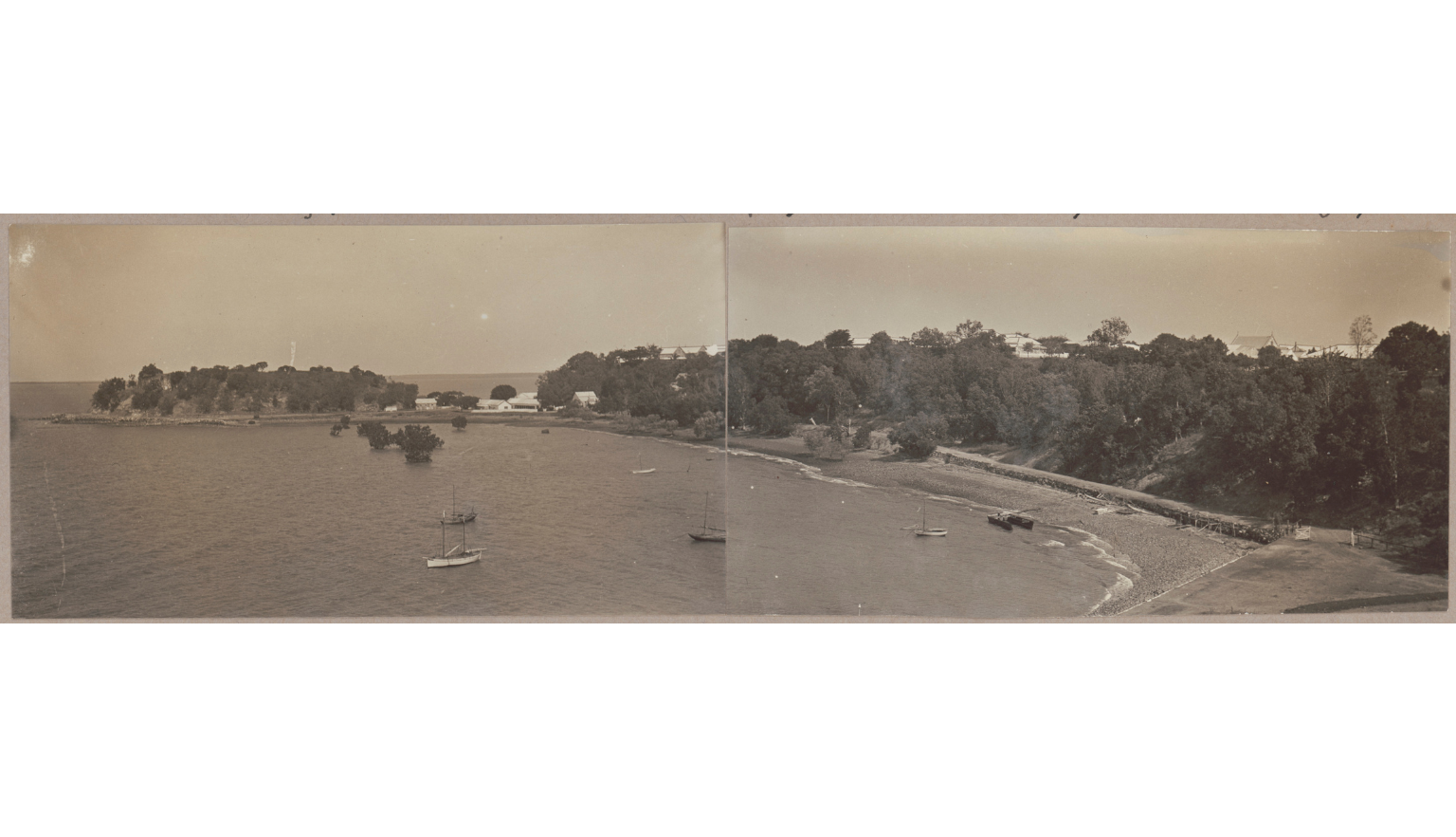 Long sepia-toned photograph with a fold line down the middle of a beach in the Northern territory with small boats in the water