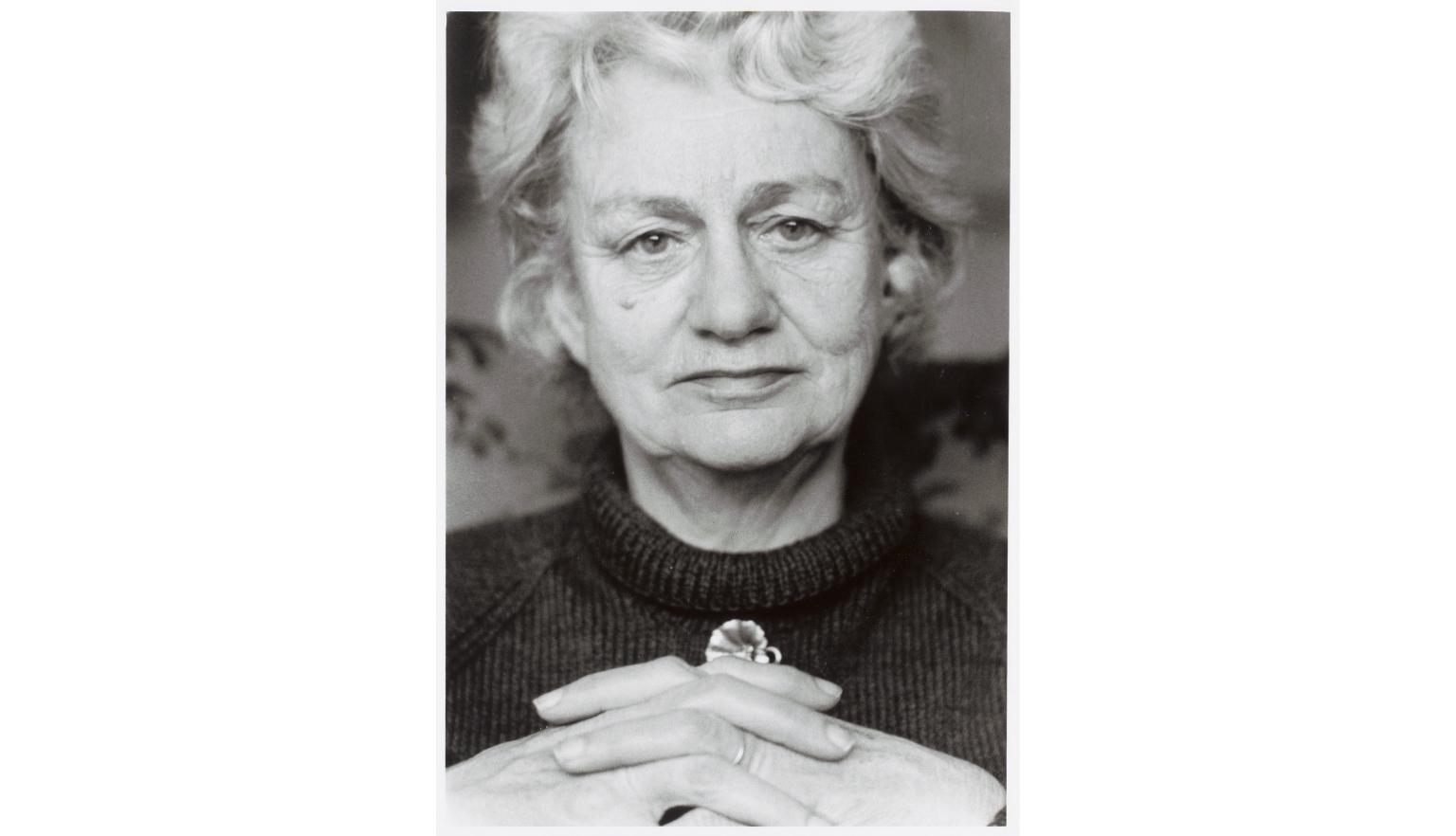 Black and white portrait of Judith Wright, with her hands crossed in front of her