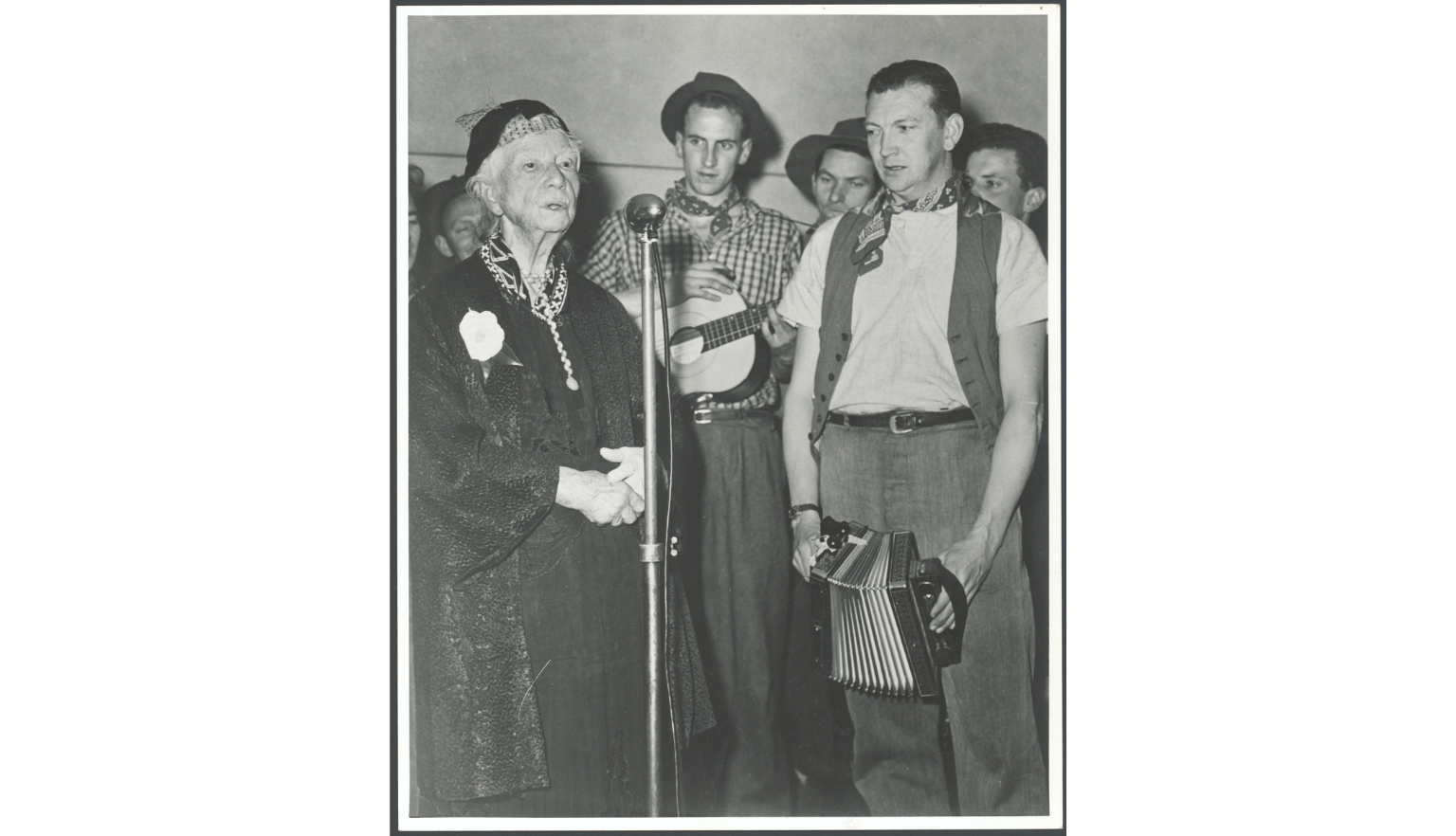 The Bushwhackers standing beside Dame Mary Gilmore as she speaks at her ninetieth birthday