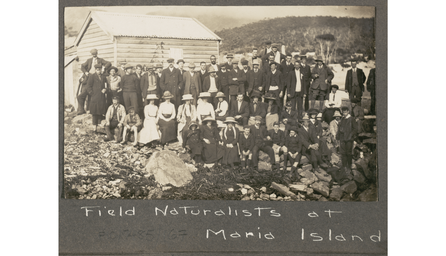 One black and white photograph of a large group of men, women and children from a Tasmanian field expedition in 1912.
