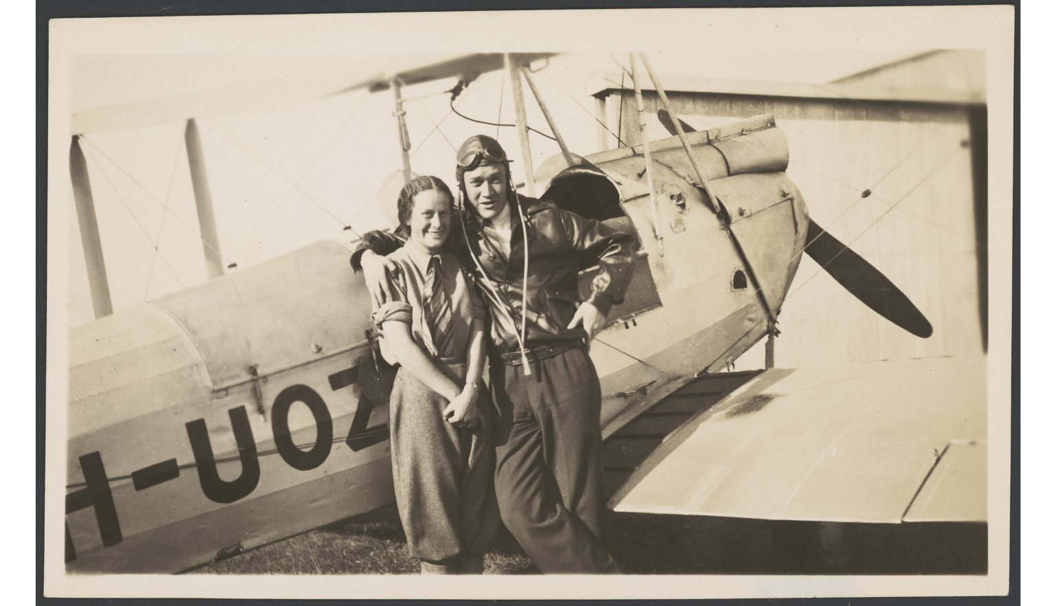 Black and white image Nancy Bird and Jack Kingsford-Smith standing in front of an aeroplane