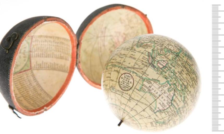 A small globe positioned to show Australia and it's shagreen case