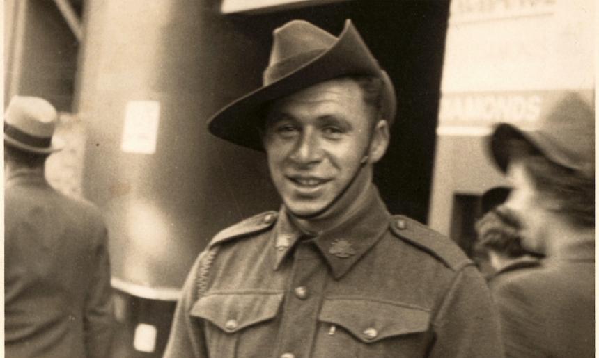 Man in military uniform with hat smiling