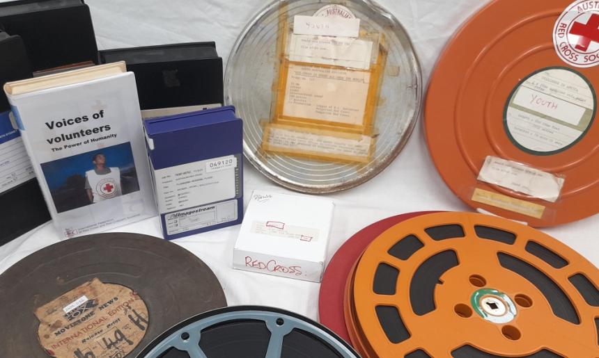 A selection of Australian Red Cross Society films in circular and rectangular cases.