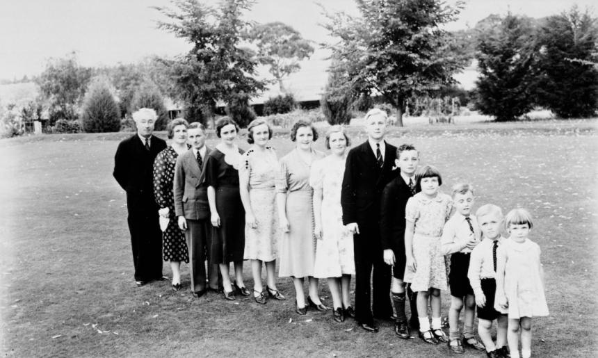 Members of a family standing in a line from oldest to youngest