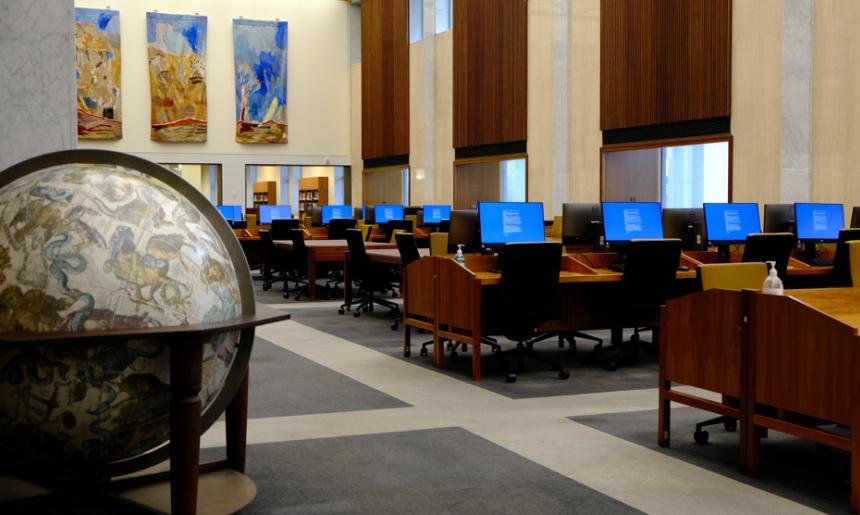 Rows of desks and computers in the Library's Main Reading Room. A large globe is in the foreground.