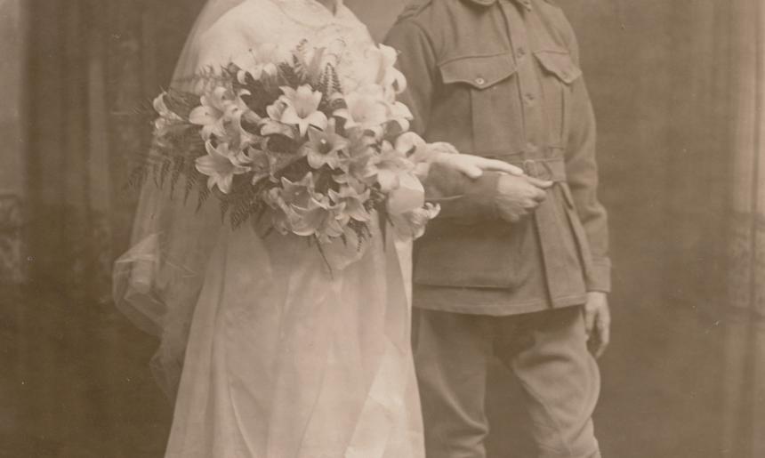 Studio portrait of a bride and groom, who was wearing military uniform