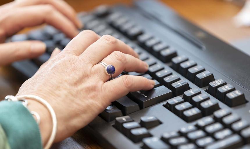 Hands typing on a keyboard