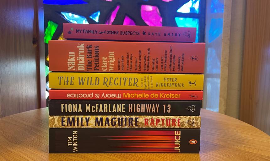 A stack of books showing the spines of selected titles shortlisted for the 2025 Prime Minister's Literary Awards