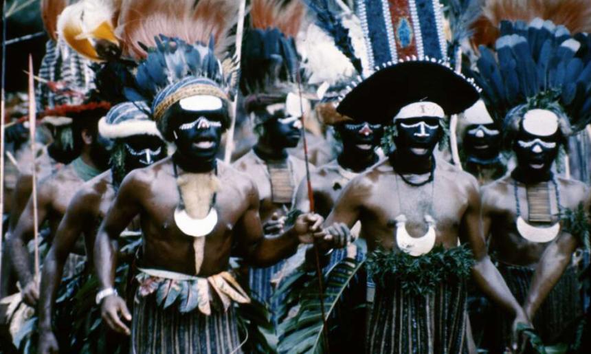 Group of Papua New Guineans in traditional dress, including feathered headpieces, at the Independence Day Celebration.