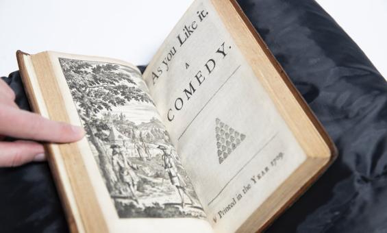 Old book open to page reading 'As You Like It: A comedy'