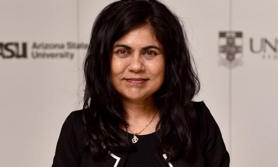 A photo of a smiling woman dressed in black