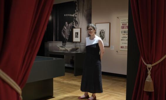 Dr Susannah Helman stands in the On Stage exhibition gallery.