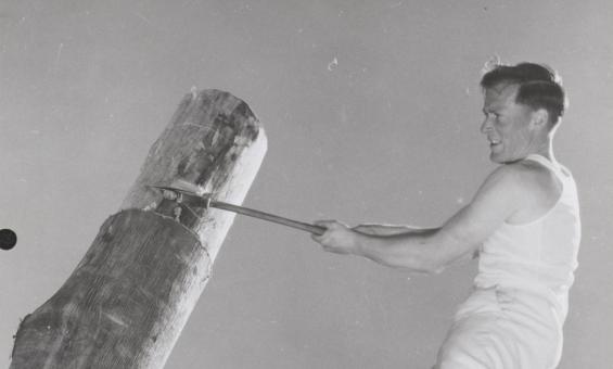 Ray Youd competing in the woodchopping event at the Royal Agricultural Show in Melbourne, Victoria, 1957