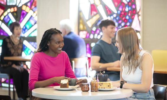 Two young women having morning tea at the Bookplate cafe