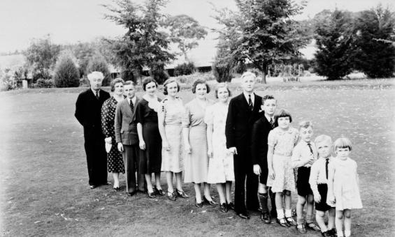 Members of a family standing in a line from oldest to youngest