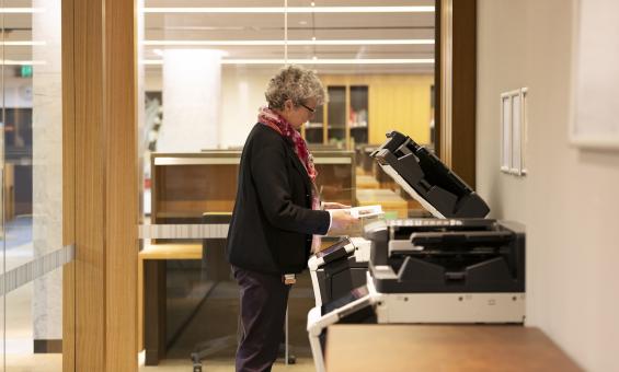 Woman using printer/photocopier in the Special Collections Reading Room