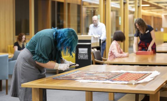 People looking at collection material and moving around the Special Collections Reading Room 