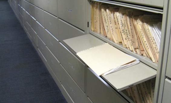 Files of newspaper clippings in a cabinet