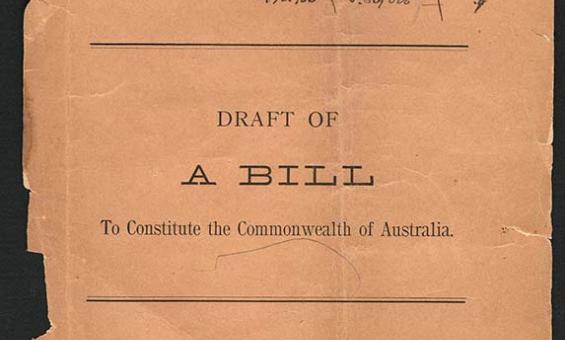 A torn buff coloured page with the words 'Draft of A Bill to Constitute the Commonwealth of Australia', with handwritten notes at the top and bottom of the page.