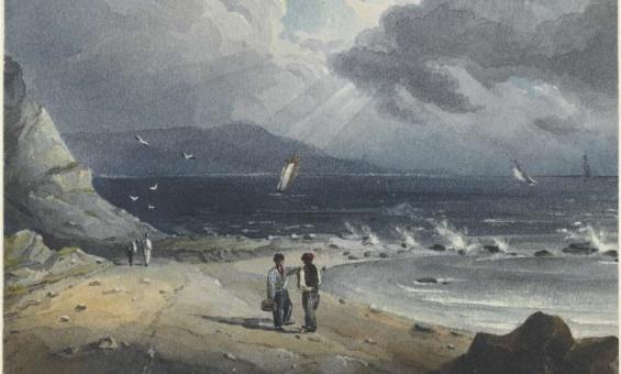 A beach on an overcast day with a stream of sunlight and water crashing on rocks. 4 people on the beach in 2 groups with 3 small boats in the background. 