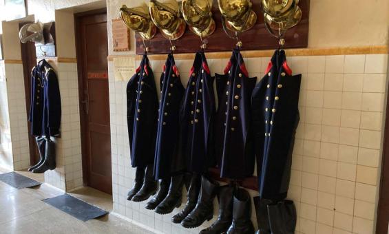 Turnout gear for firemen hanging in the engine bay of the Canberra Fire Museum