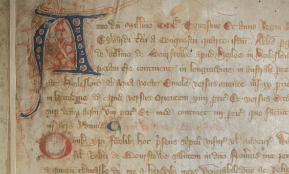 Close up of page of old, rare Latin book with a stylised letter A in the top left