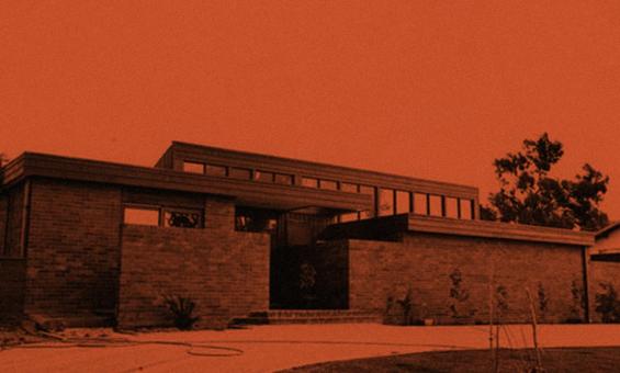 Orange and black stylised image of a house