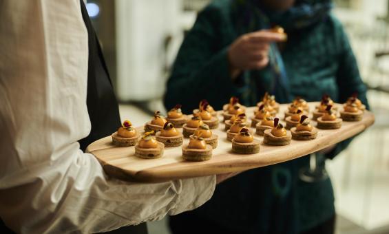 Event catering with a wooden tray of bite size treats