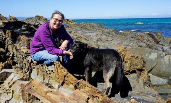Photo of 'Dog Beach' author at the beach with her dog Banjo on a sunny day